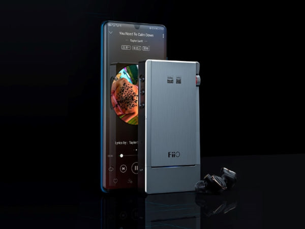 The FiiO Q5S stands in front of a smart phone